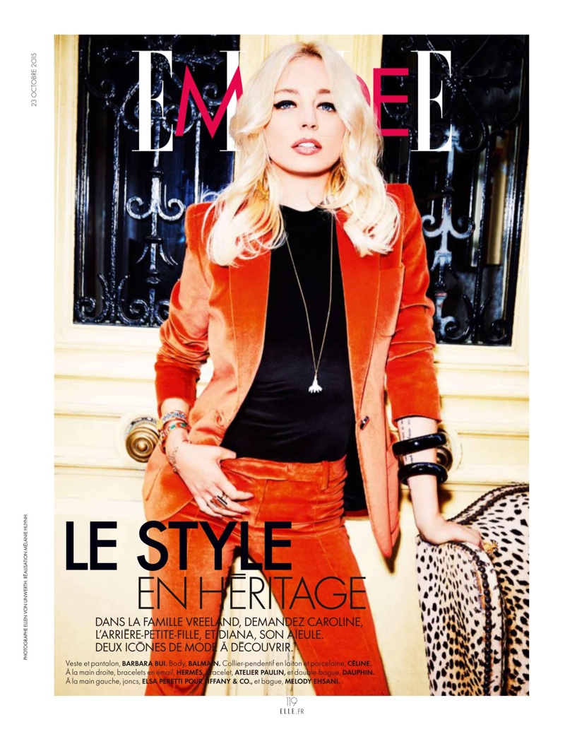 A magazine cover of Caroline Vreeland in Elle wearing a red suit and black shirt