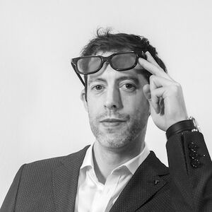 William Entriken black and white photo with him holding sunglasses on his forehead